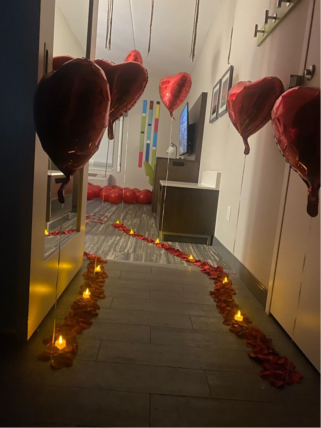 Candlelit petal path leading through a hotel room