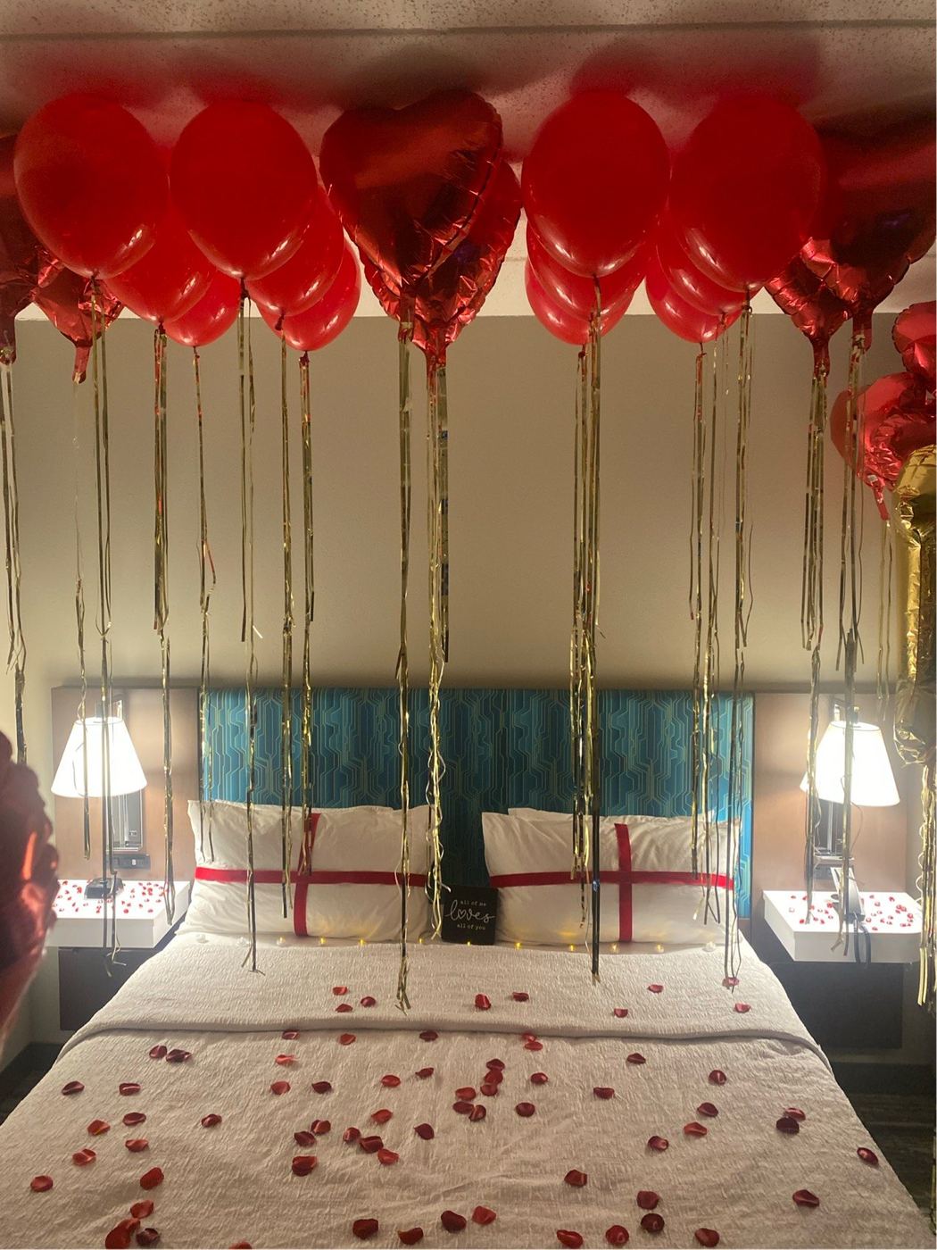 Romantic hotel room with heart balloon canopy